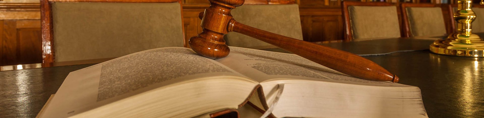 Photo of wooden judge's gavel in the library, focus on the gavel