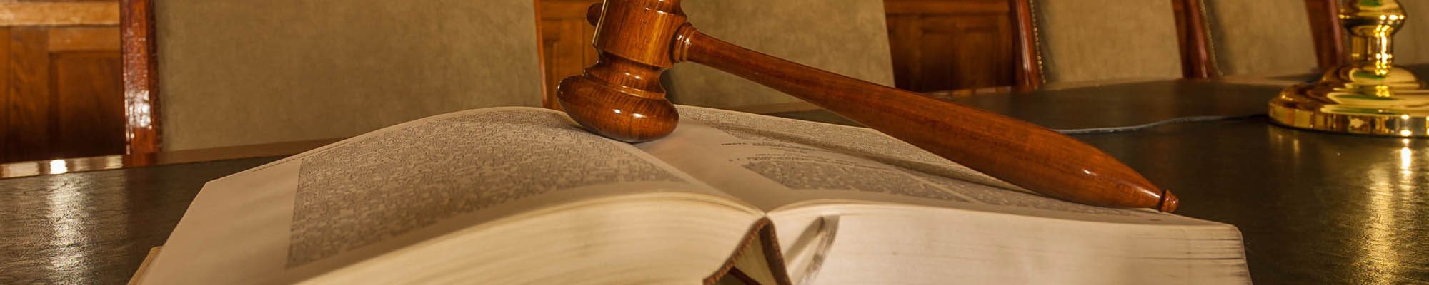 Photo of wooden judge's gavel in the library, focus on the gavel