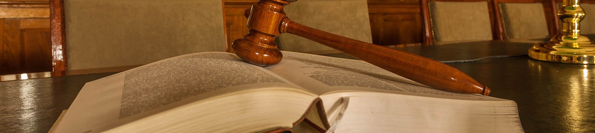 Photo of wooden judge's gavel in the library, focus on the gavel